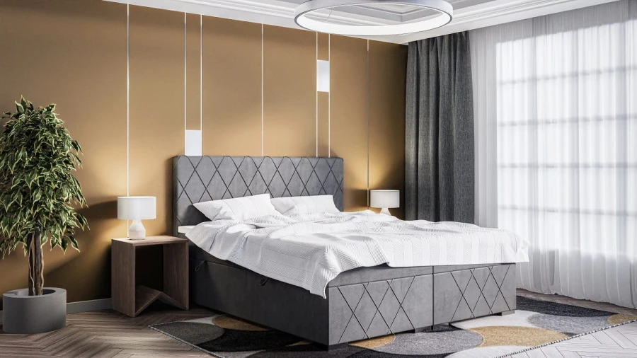 Eingerichtetes Schlafzimmer mit grauem Boxspringbett, Teppich und moderner Zimmerbeleuchtung.