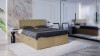 Modernes Boxspringbett in Beige mit grauer Bettwäsche in einem stilvollen Schlafzimmer.
