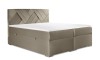 Modernes Boxspringbett in Taupe mit dekorativ gemustertem Kopfteil.