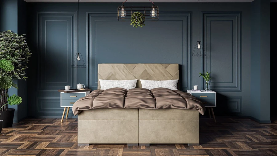 Stilvolles Schlafzimmer-Design mit Boxspringbett vor dunkelblauer Wand.