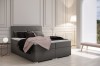 Stilvolles graues Boxspringbett mit geometrischer Steppung im Kopfteil.