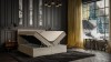 Beige gepolstertes Boxspringbett mit offenem Bettkasten in modernem Schlafzimmer.