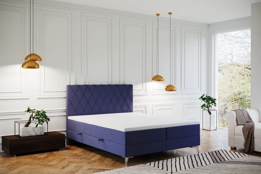 Modernes Boxspringbett in Blau mit dekorativem Rauten-Kopfteil und weißer Matratze.