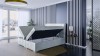 Modernes Polsterbett in Hellgrau mit geöffneten Bettkästen für praktischen Stauraum im Schlafzimmer.