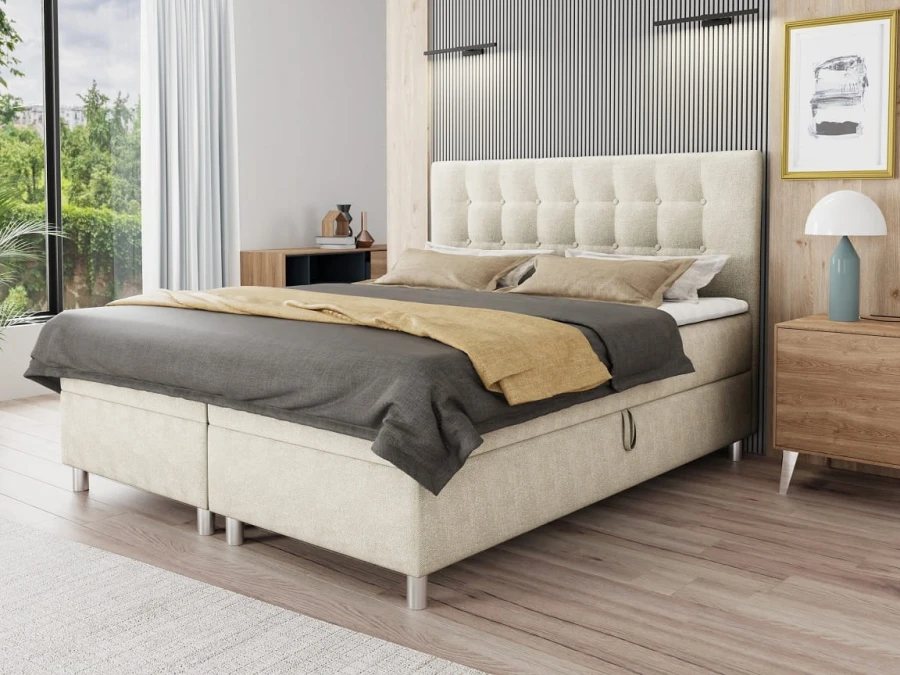 Modernes beige Boxspringbett mit gestepptem Kopfteil und Bettkasten im hellen Schlafzimmer.