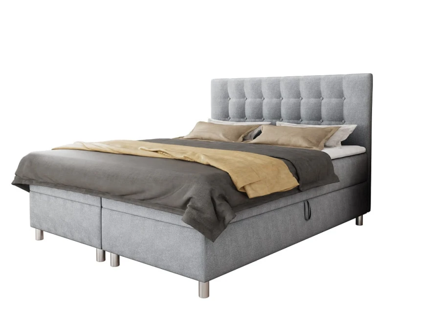 Elegantes graues Boxspringbett mit Knopfsteppung am Kopfteil, freigestellt auf weißem Hintergrund.