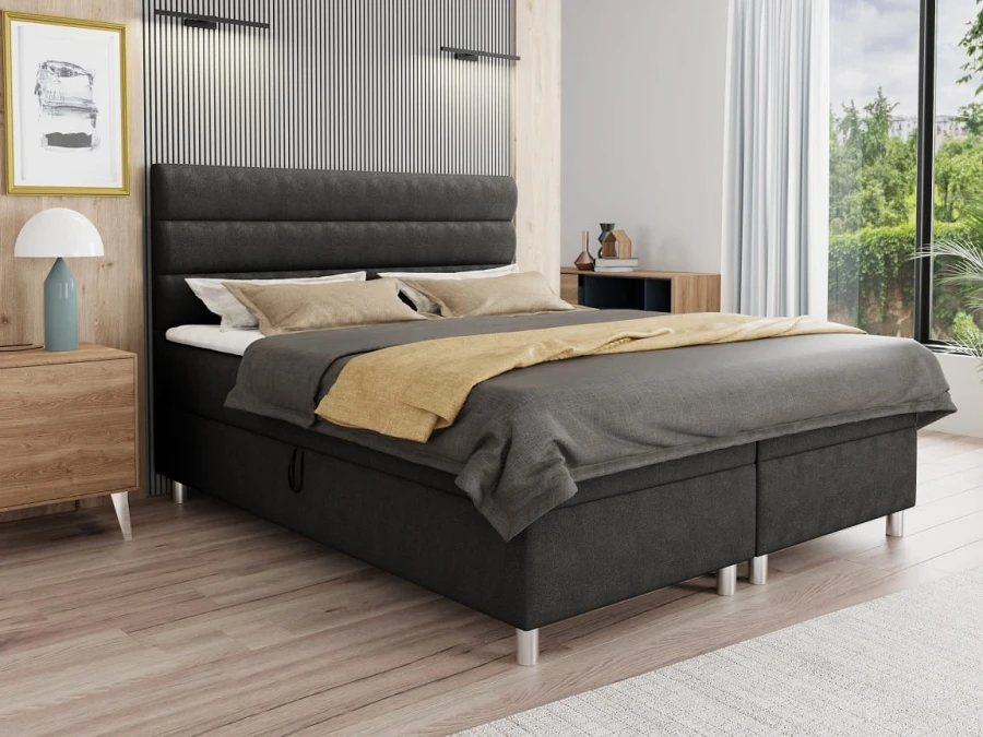 Modernes Boxspringbett in Anthrazit mit hohem Kopfteil im Schlafzimmer.