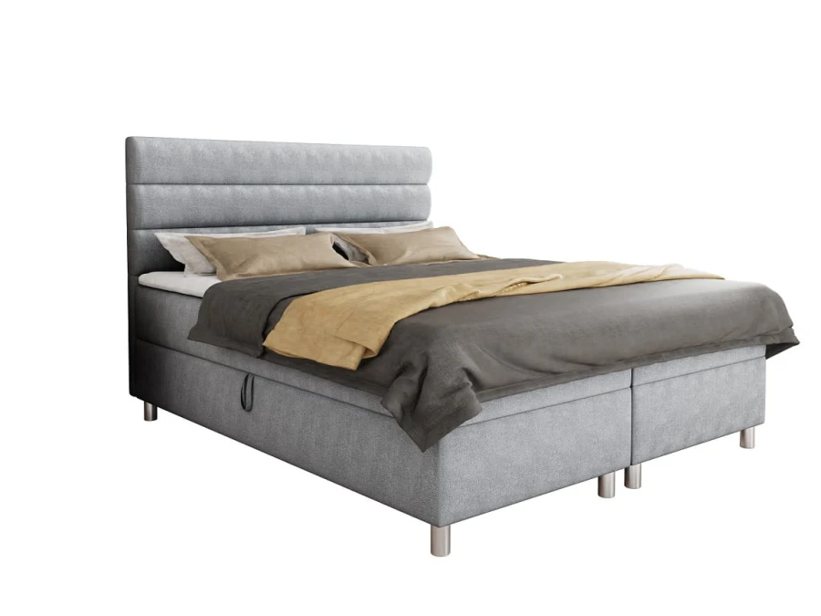 Freigestelltes hellgraues Boxspringbett mit modernem Kopfteil-Design.