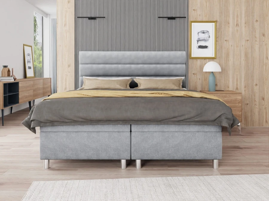 Modernes graues Boxspringbett mit gepolstertem Kopfteil im stilvollen Schlafzimmer.