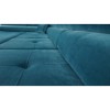 Nahaufnahme der gesteppten Sitzfläche eines blauen Ecksofas aus Samt.