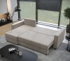 Beiges Ecksofa mit Schlaffunktion, ausgeklappt als bequemes Gästebett im Wohnzimmer.