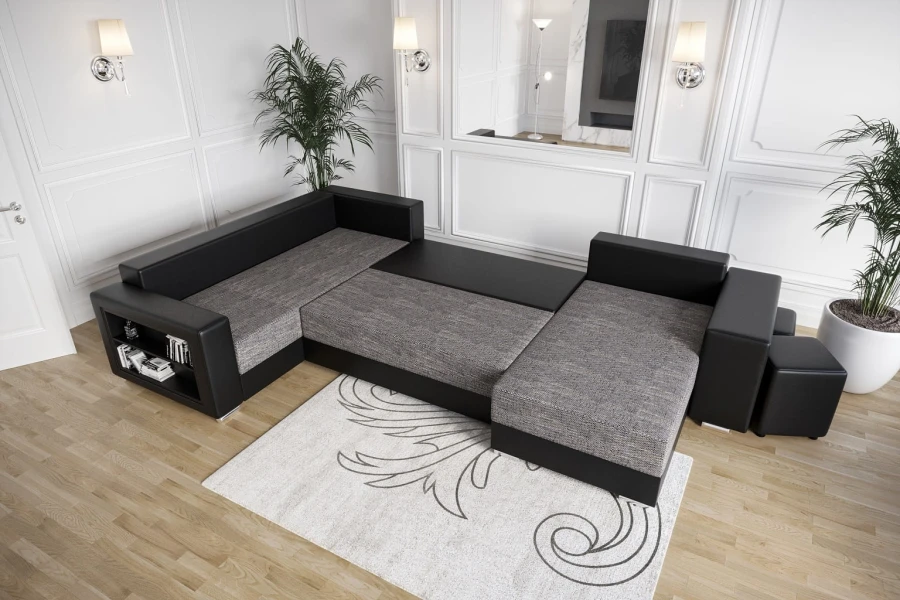 Modernes Schlafsofa in Schwarz und Grau, ausgezogen in einem hellen Wohnzimmer.