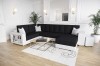 Modernes U-förmiges Sofa in Weiß-Schwarz mit Zierkissen in luxuriösem Ambiente.