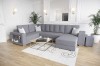 Modernes graues Ecksofa in einem hellen Wohnzimmer mit Couchtisch und weißen Kissen.
