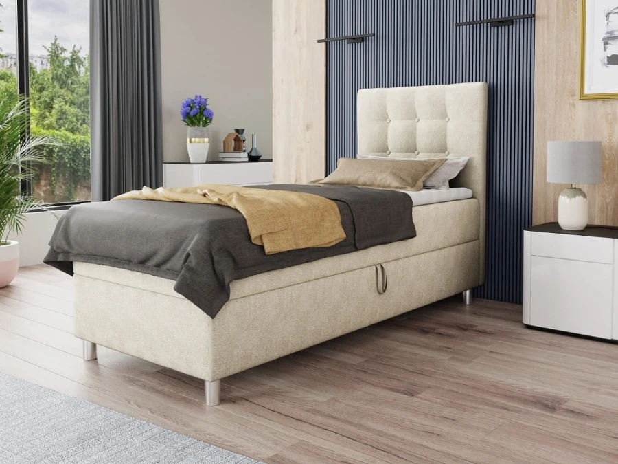 Beiges Boxspringbett für eine Person in modernem Schlafzimmer-Ambiente mit Holzdekor.