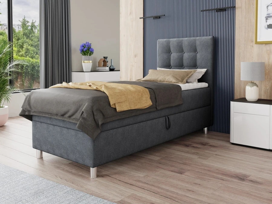 Modernes graues Boxspringbett im Schlafzimmer mit gestepptem Kopfteil.
