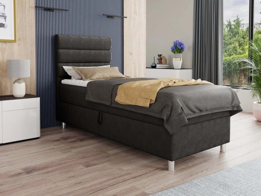 Modernes anthrazitfarbenes Boxspringbett im Schlafzimmer mit gestepptem Kopfteil.