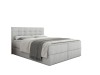 Hochwertiges graues Boxspringbett mit dekorativer Knopfheftung am Kopfteil vor weißem Hintergrund.