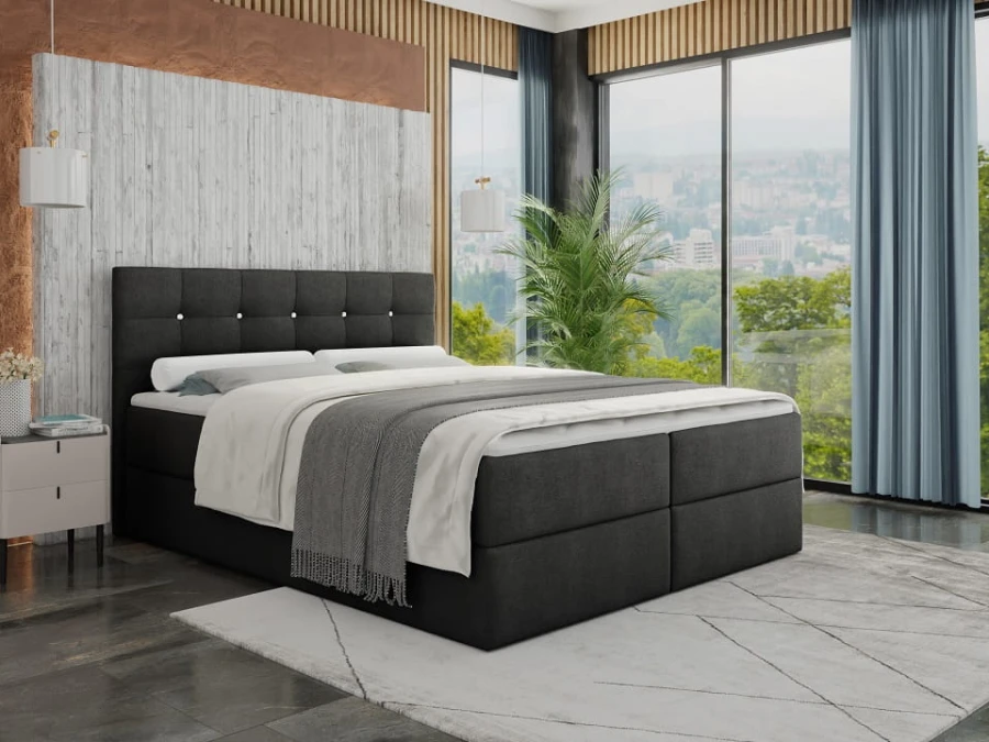 Modernes Boxspringbett in Anthrazit mit gepolstertem Kopfteil und dekorativen Knöpfen im Schlafzimmer.