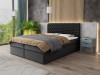 Modernes dunkelgraues Boxspringbett mit gestepptem Kopfteil im Schlafzimmer.