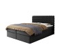 Schwarzes Boxspringbett mit Chesterfield-Steppung isoliert auf weißem Hintergrund.