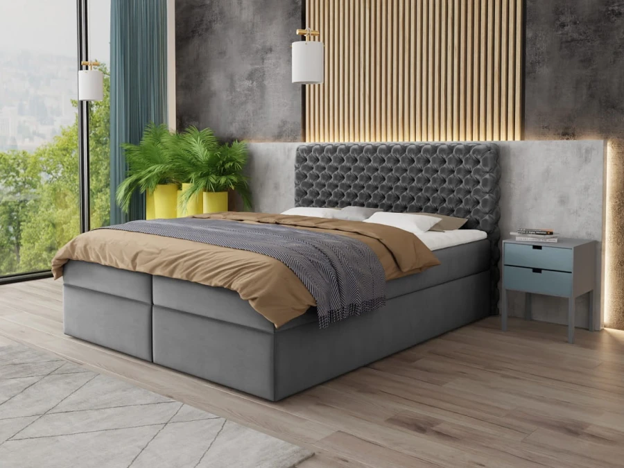 Graues Boxspringbett mit dekorativer Steppung in hellem Schlafzimmer.