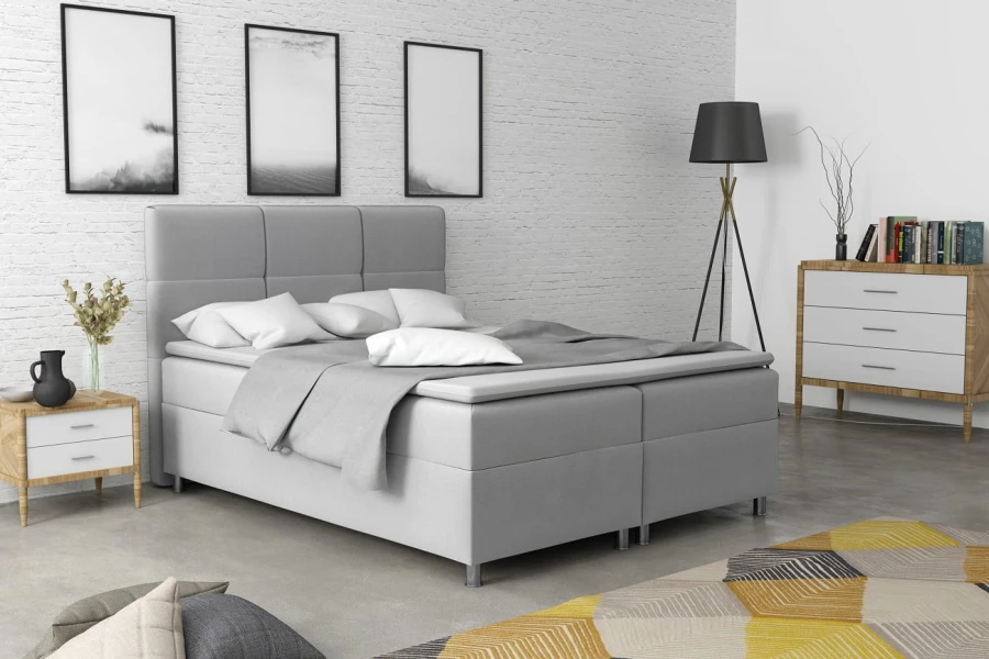 Modernes Boxspringbett in Grau mit gepolstertem Kopfteil für das Schlafzimmer.
