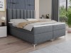 Graues Boxspringbett mit modernem Design und gestepptem Kopfteil.
