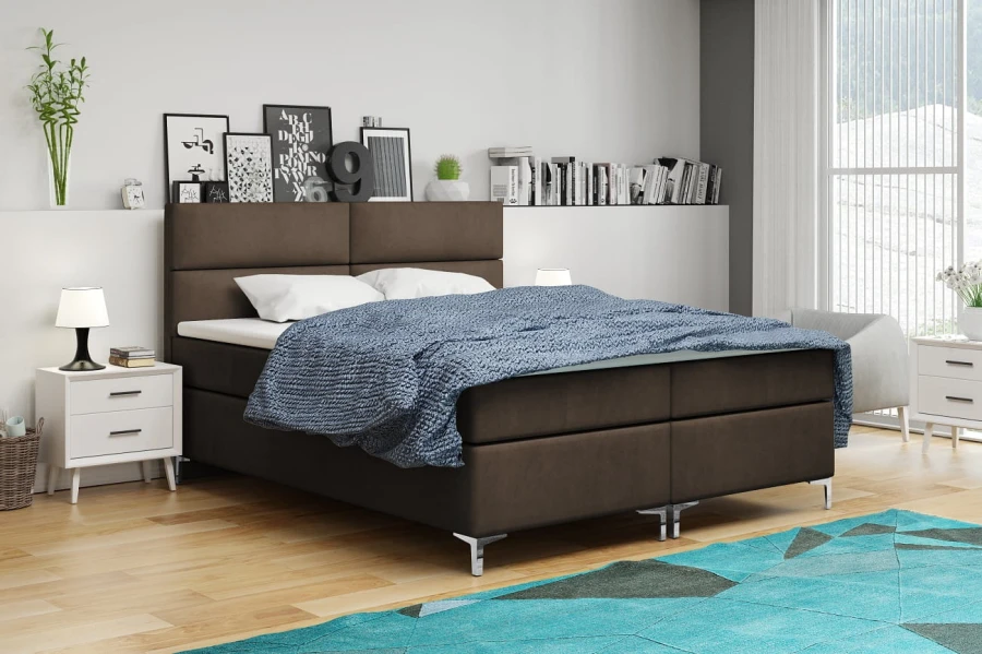 Braunes Boxspringbett mit blauer Decke im modern eingerichteten Schlafzimmer.