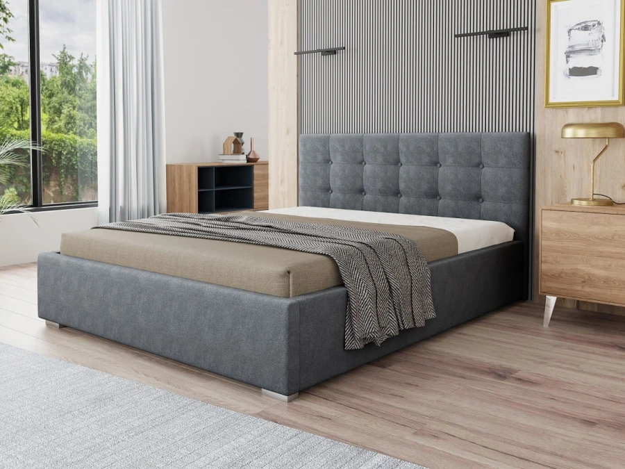 Modernes graues Polsterbett mit gestepptem Kopfteil in einem hellen Schlafzimmer.