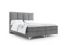 Graues Boxspringbett mit gepolstertem Kopfteil und weißer Bettwäsche auf weißem Hintergrund.