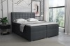 Dunkelgraues Boxspringbett mit gestepptem Kopfteil in einem modernen Schlafzimmer im Loft-Stil.