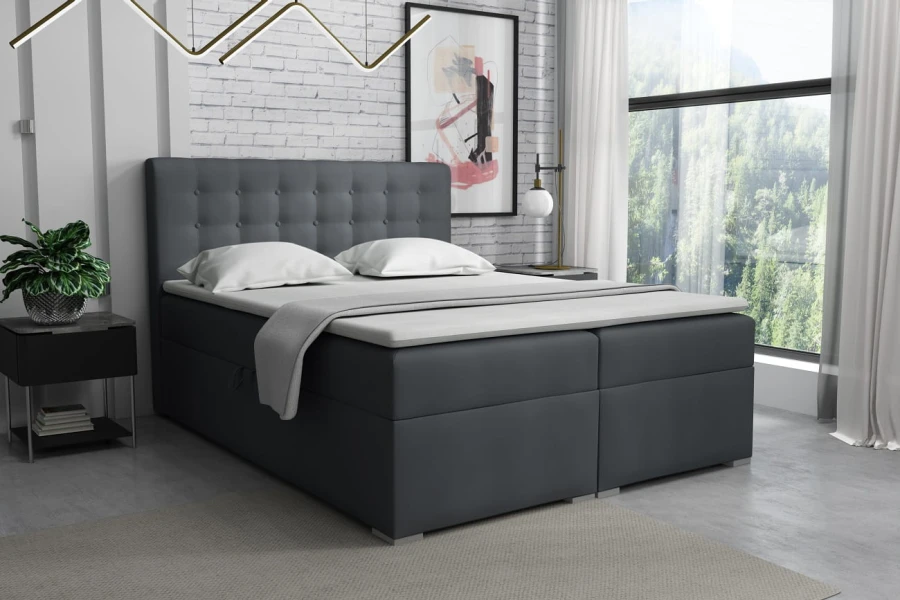 Dunkelgraues Boxspringbett mit gestepptem Kopfteil in einem modernen Schlafzimmer im Loft-Stil.