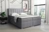 Hellgraues Boxspringbett aus Strukturstoff mit Knopfsteppung in modernem Schlafzimmer-Ambiente.
