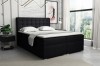 Schwarzes Boxspringbett mit gestepptem Kopfteil in modernem Schlafzimmer.