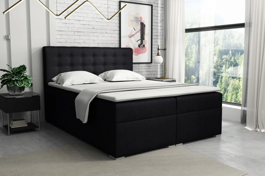 Schwarzes Boxspringbett mit gestepptem Kopfteil in modernem Schlafzimmer.