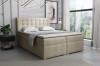 Beiges Boxspringbett mit dekorativer Knopfheftung für erholsamen Schlaf.
