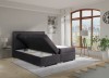 Dunkelgraues Boxspringbett mit seitlich aufklappbaren Bettkästen für Stauraum.