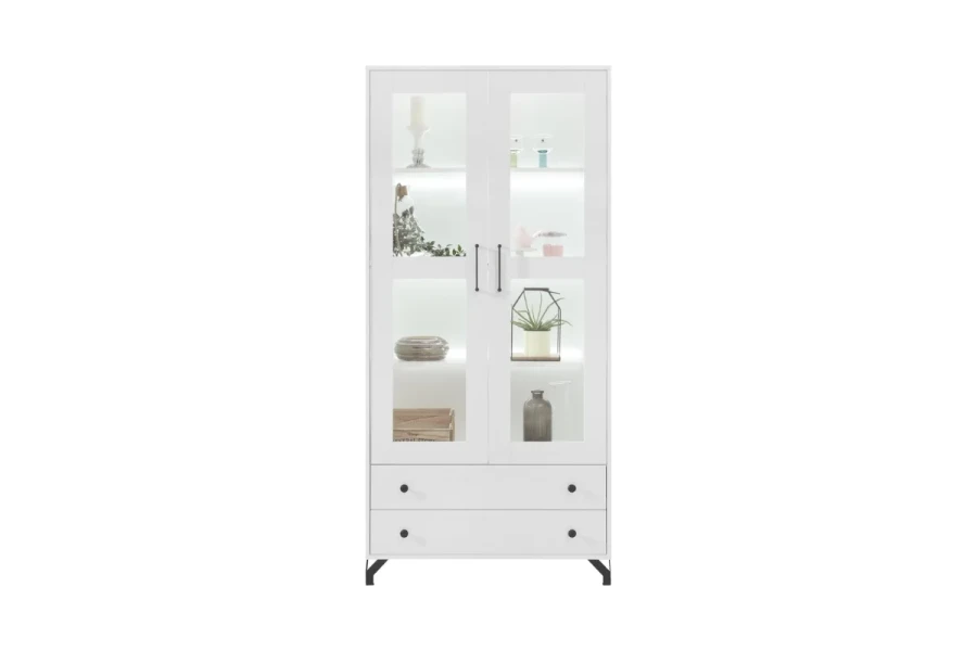 Weiße Vitrine mit Glastüren, LED-Beleuchtung und zwei Schubladen auf schwarzen Metallfüßen.