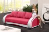 Pink-weißes Designer-Sofa im hellen Wohnzimmer mit Frau auf der Armlehne.