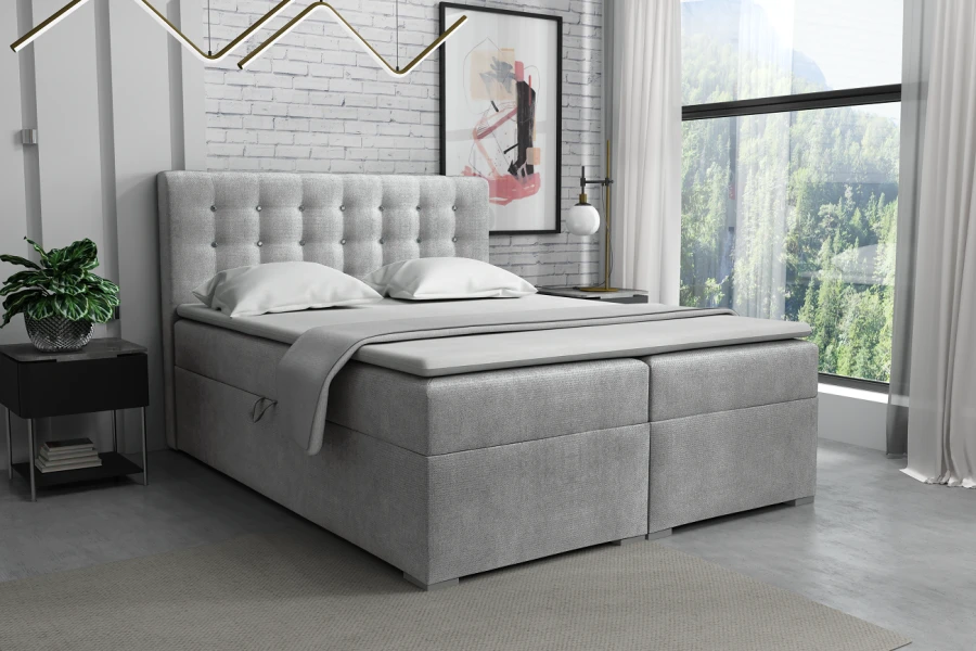 Hellgraues Boxspringbett mit edler Knopfheftung am Kopfteil für ein gemütliches Schlafzimmer.