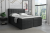 Anthrazitfarbenes Boxspringbett mit gepolstertem Kopfteil und Kristalldetails im Schlafzimmer.
