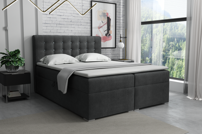 Dunkelgraues Boxspringbett mit gestepptem Kopfteil und gemütlicher Ausstattung für das Schlafzimmer.