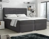 Dunkelgraues Boxspringbett mit strukturiertem Kopfteil in einem modernen Schlafzimmer.