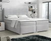 Hellgraues Boxspringbett mit modernem gestreiftem Kopfteil in gemütlicher Schlafzimmer-Umgebung.