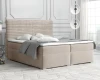 Beiges Boxspringbett mit Kopfteil in Cord-Optik und grauer Bettwäsche