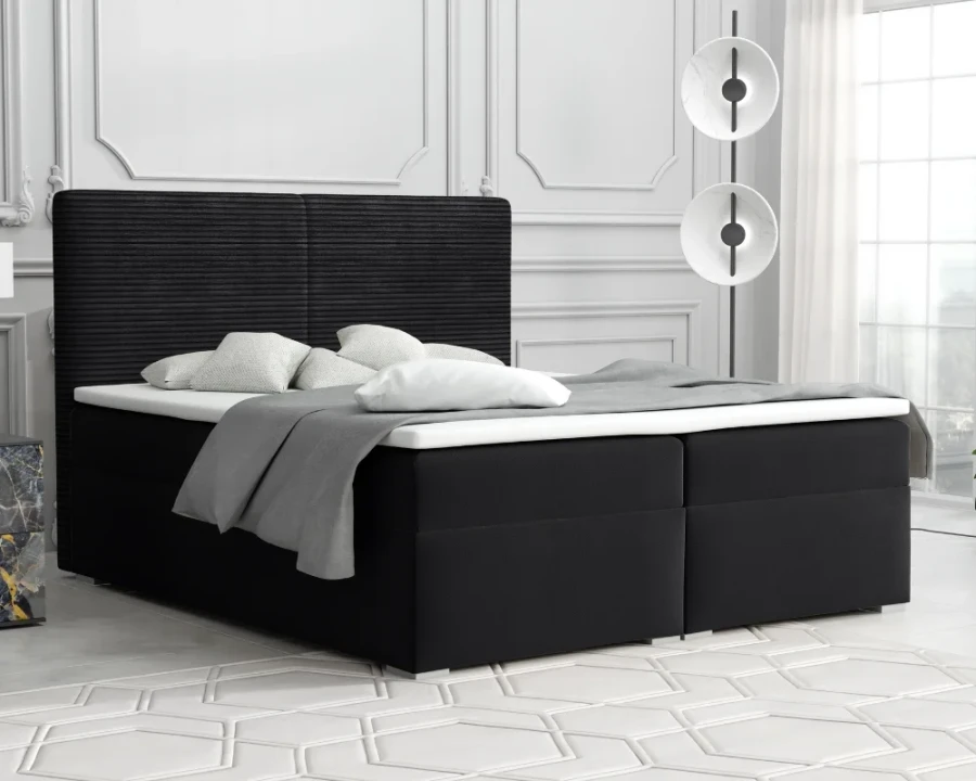 Elegantes schwarzes Boxspringbett mit Polster-Kopfteil in luxuriösem Ambiente.