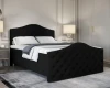 Elegantes schwarzes Polsterbett mit gestepptem Kopfteil und Fußteil in einem modern eingerichteten Schlafzimmer.