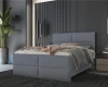 Graues Polsterbett im modernen Design, platziert in einem eleganten Schlafzimmer mit dunklen Akzenten.