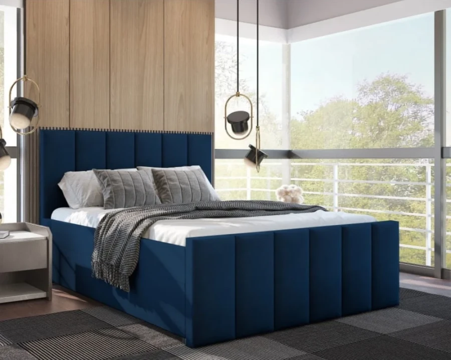 Modernes blaues Polsterbett mit gestepptem Kopfteil im hellen Schlafzimmer.